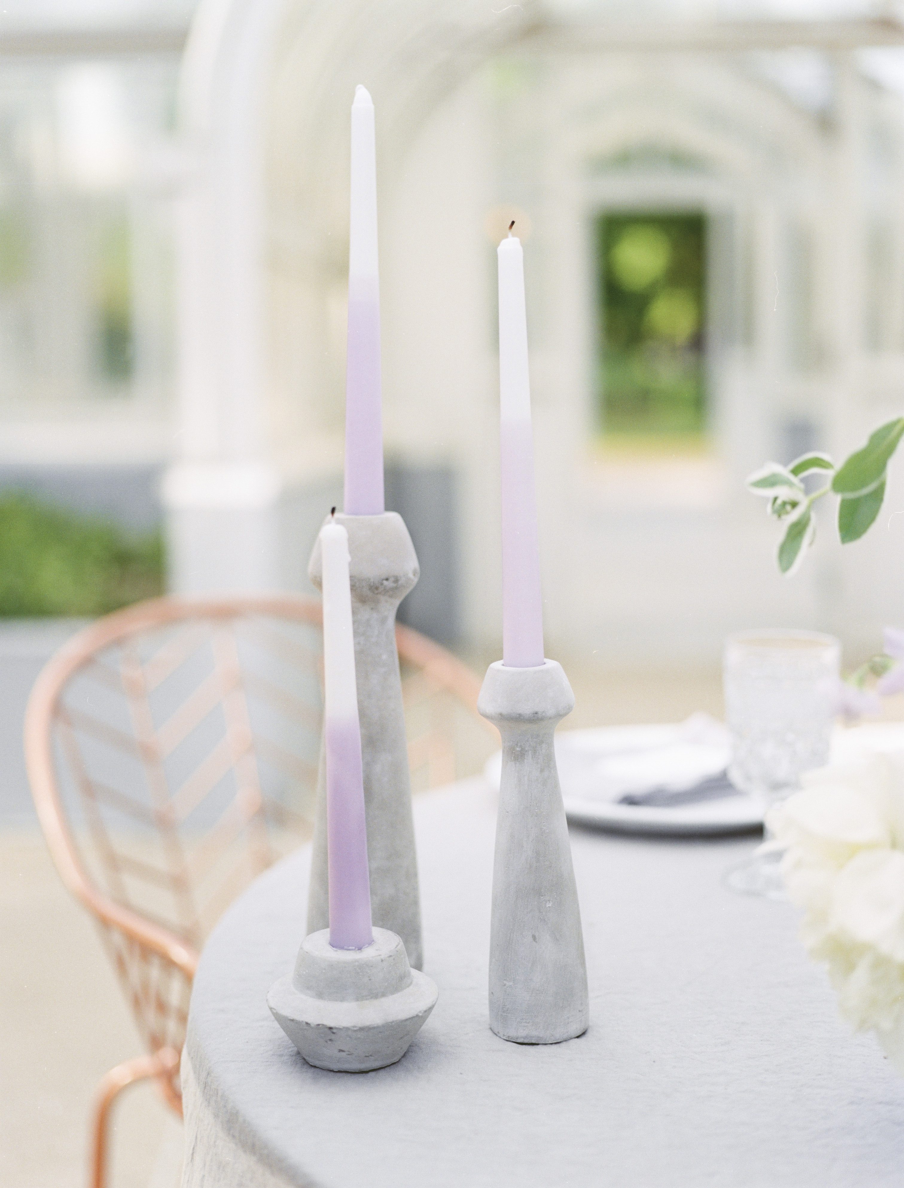 dip dyed candles in concrete candle holders at a lavender and copper wedding