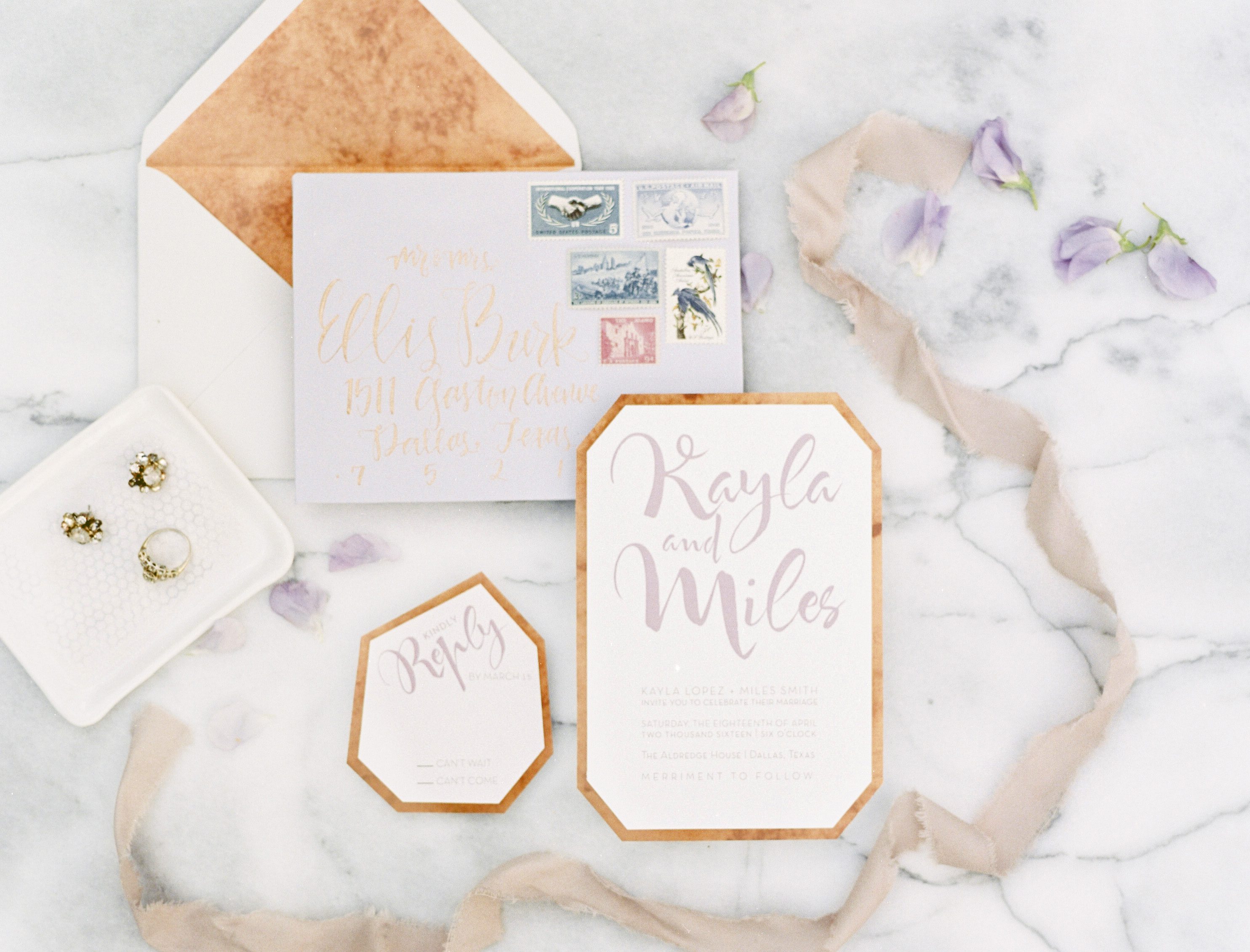 geometric invitation suite styled on marble at a lavender and copper wedding