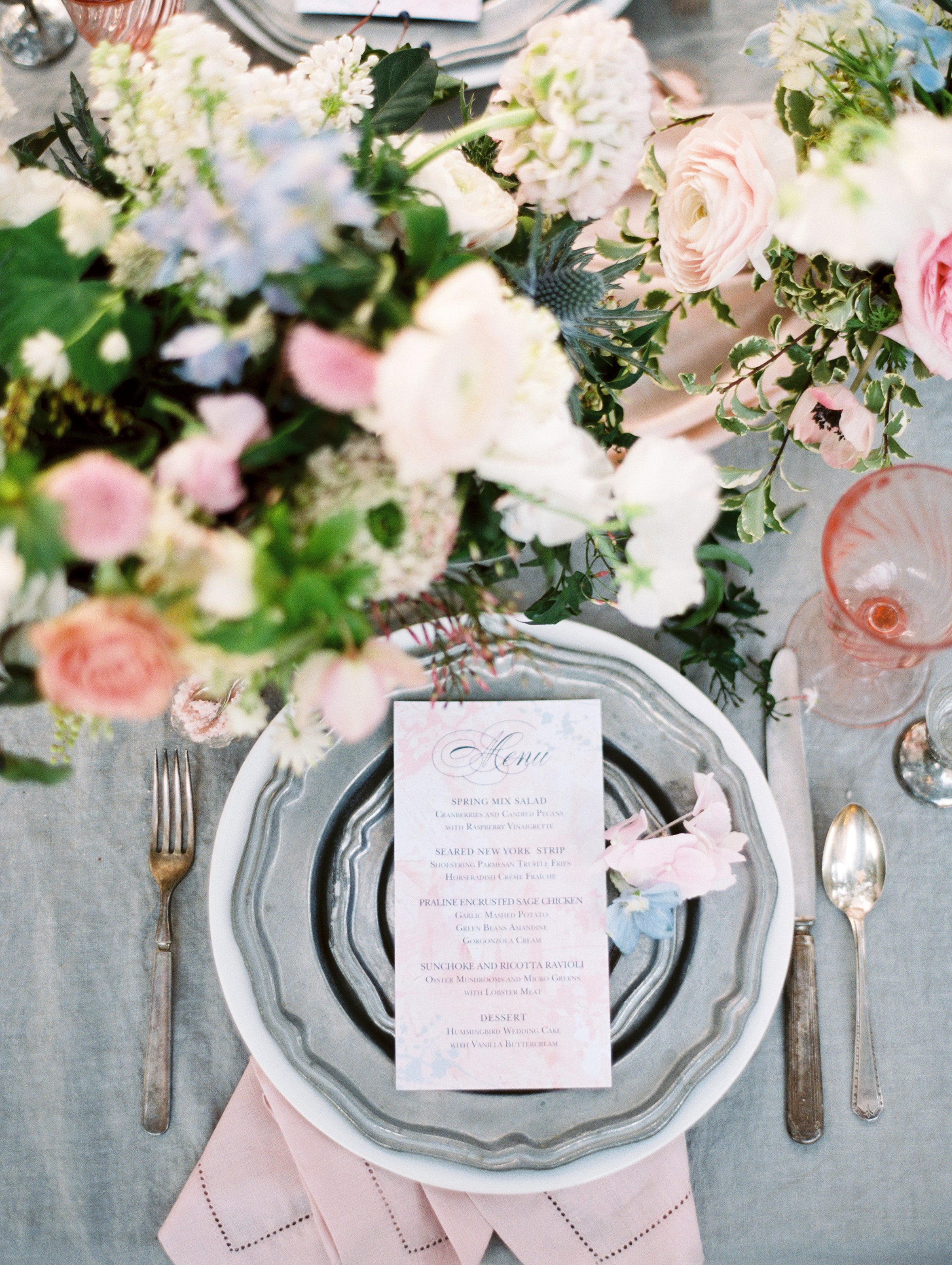 pink and blue place setting with metals plates