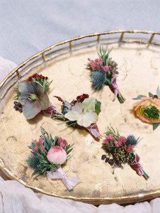 Hellebore boutonnieres styled on a vintage tray