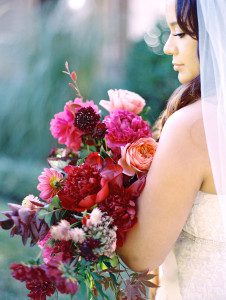 bride holding pink and burgundy bouquet