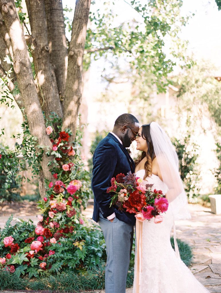 bride and groom in front of floral altar at a Dallas outdoor elopement
