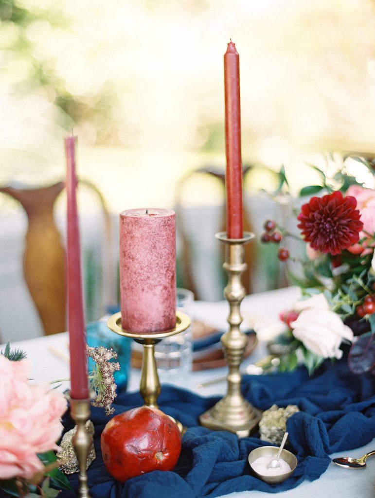 Burgundy pillar and taper candles on blue table runner at a Dallas outdoor elopement