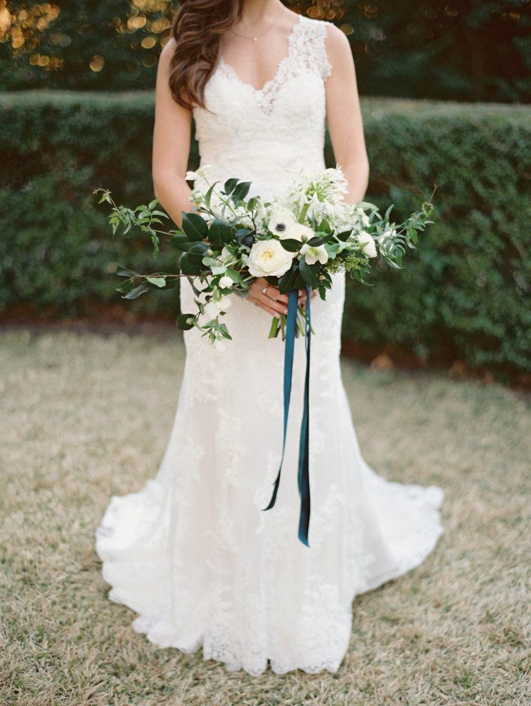 Bride is wearing Melanie by Maggie Sottero while carrying white blooms  at a Dallas elopement at the Aldredge House