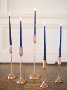 Navy taper candles in gold candleholders