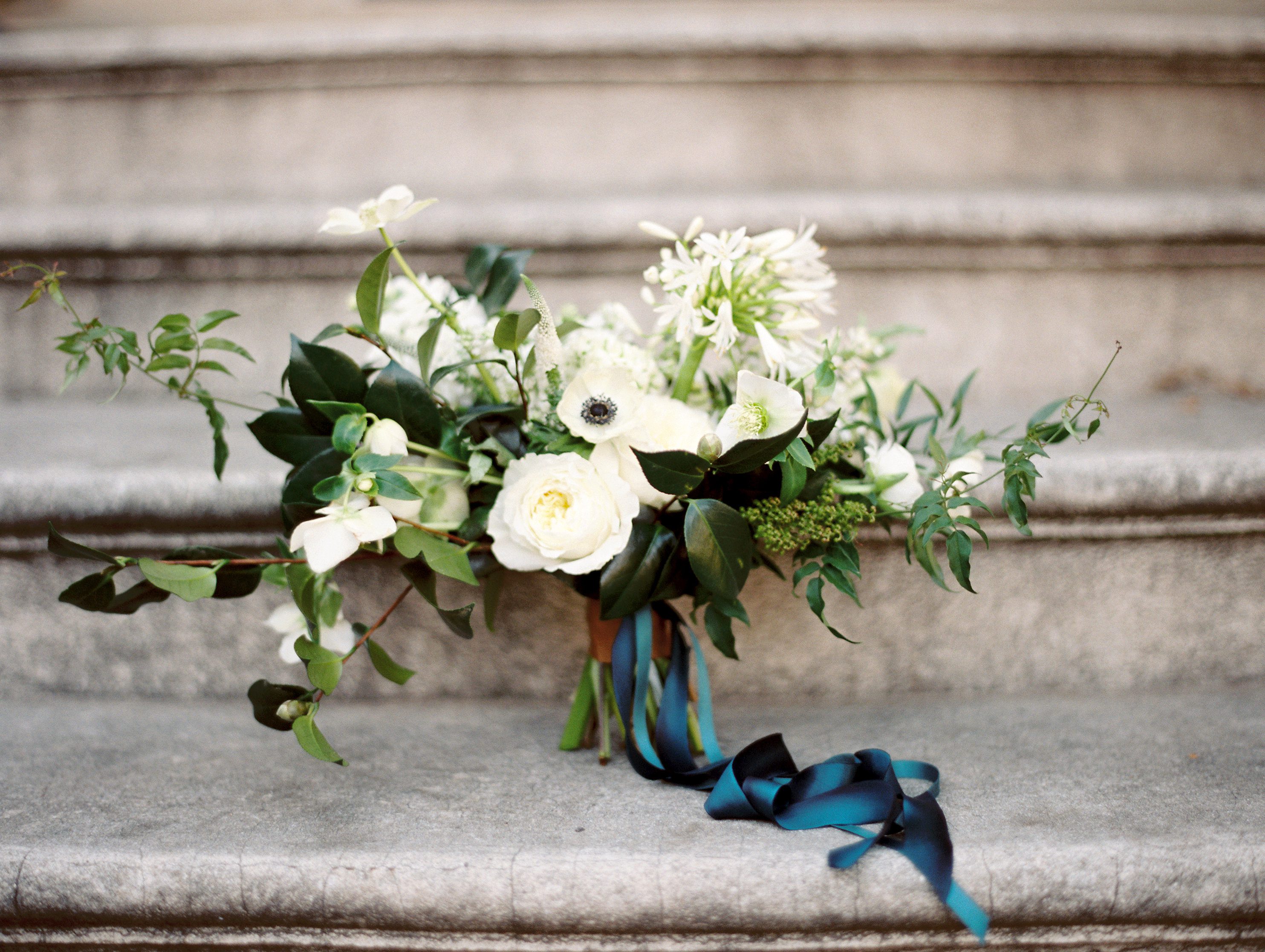 White floral blooms tied with an indigo ribbon