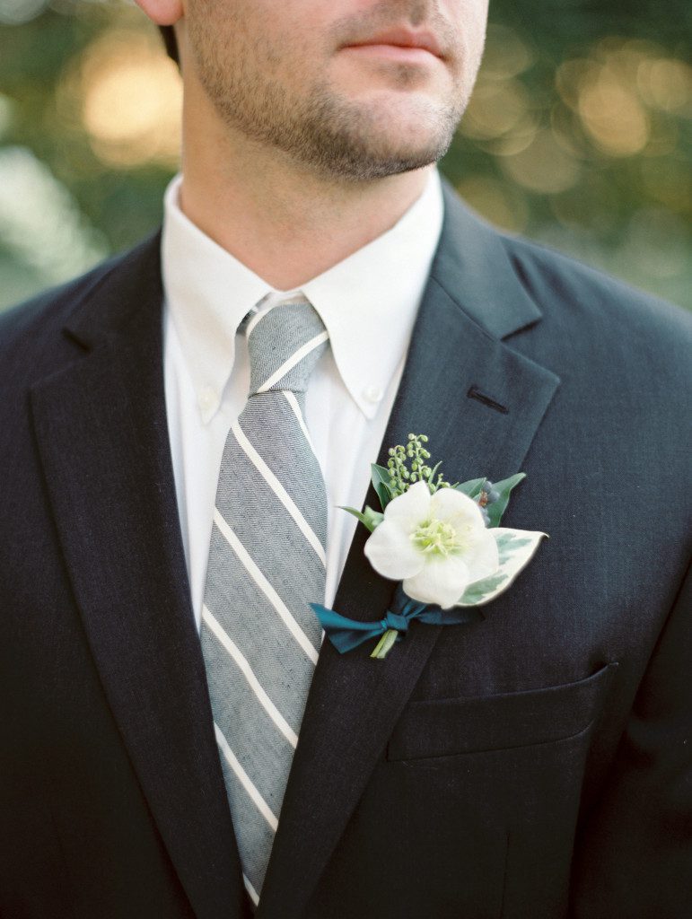 White boutonniere on a dark grey suit at a Dallas elopement at the Aldredge House