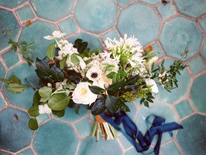 White bouquet tied with a navy ribbon