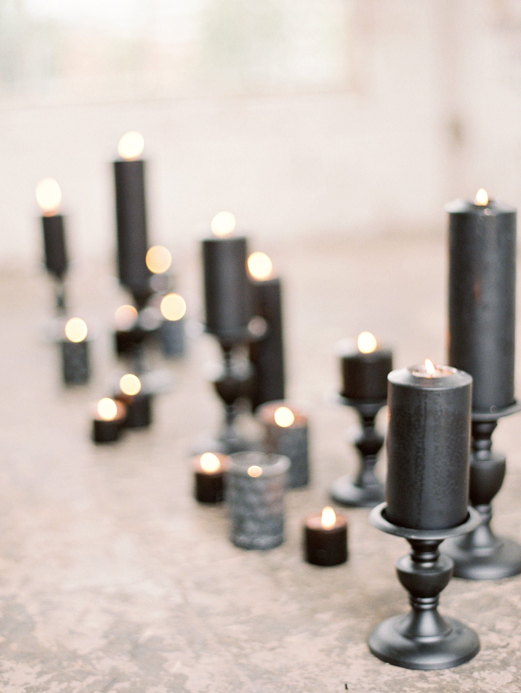 Black pillar candles on black candleholders