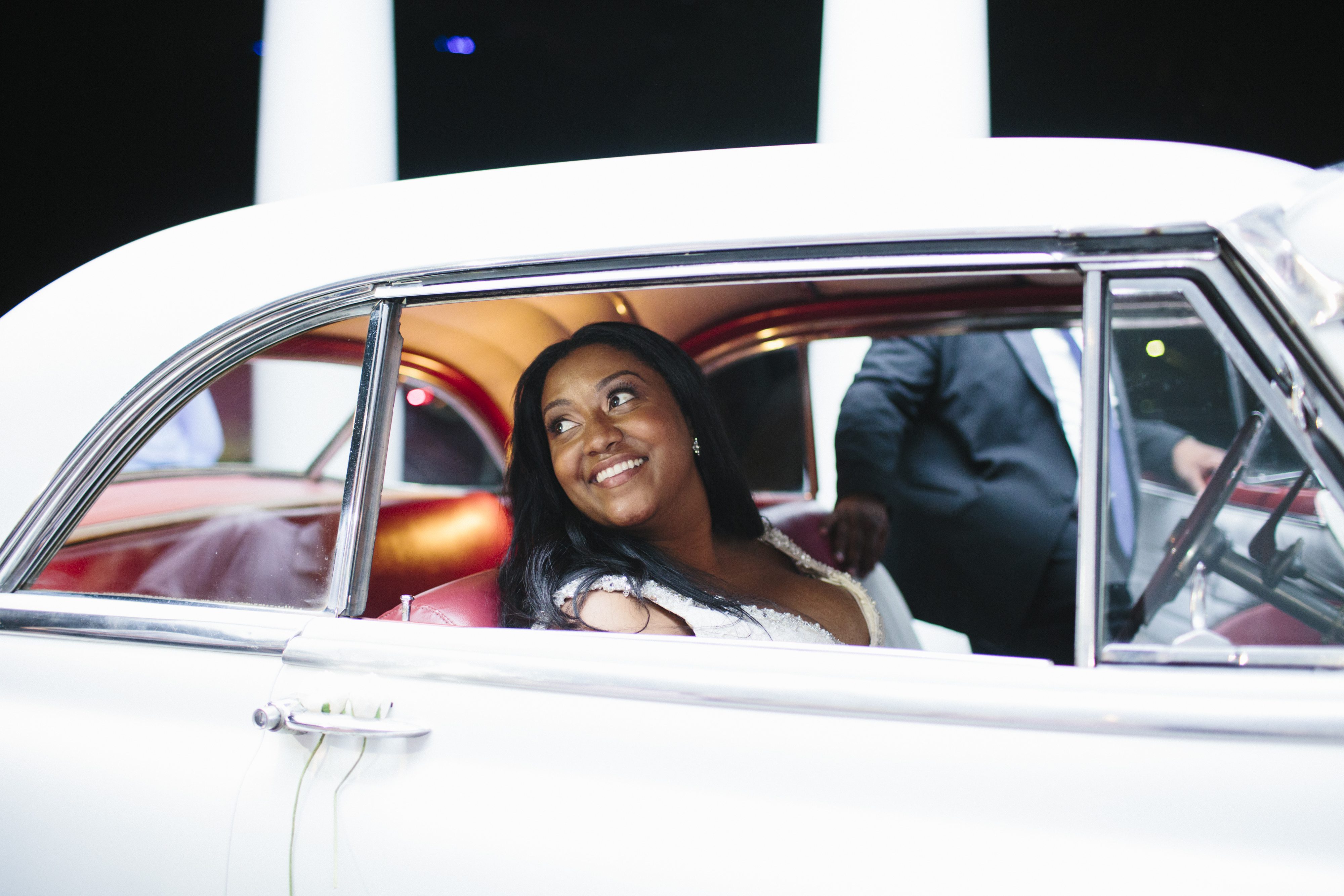 Bride and groom getaway in a vintage car