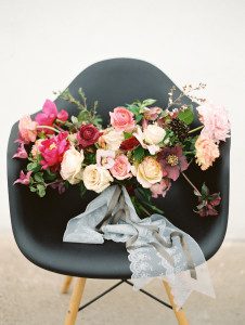 Marsala themed wedding bouquet displayed in black chair