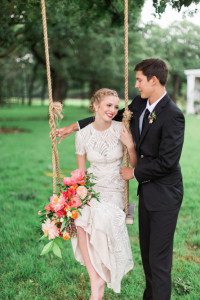 Bride and groom swing at rustic wedding venue