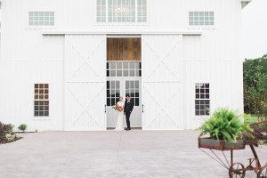 Bride and groom at entrance to White Sparrow Barn