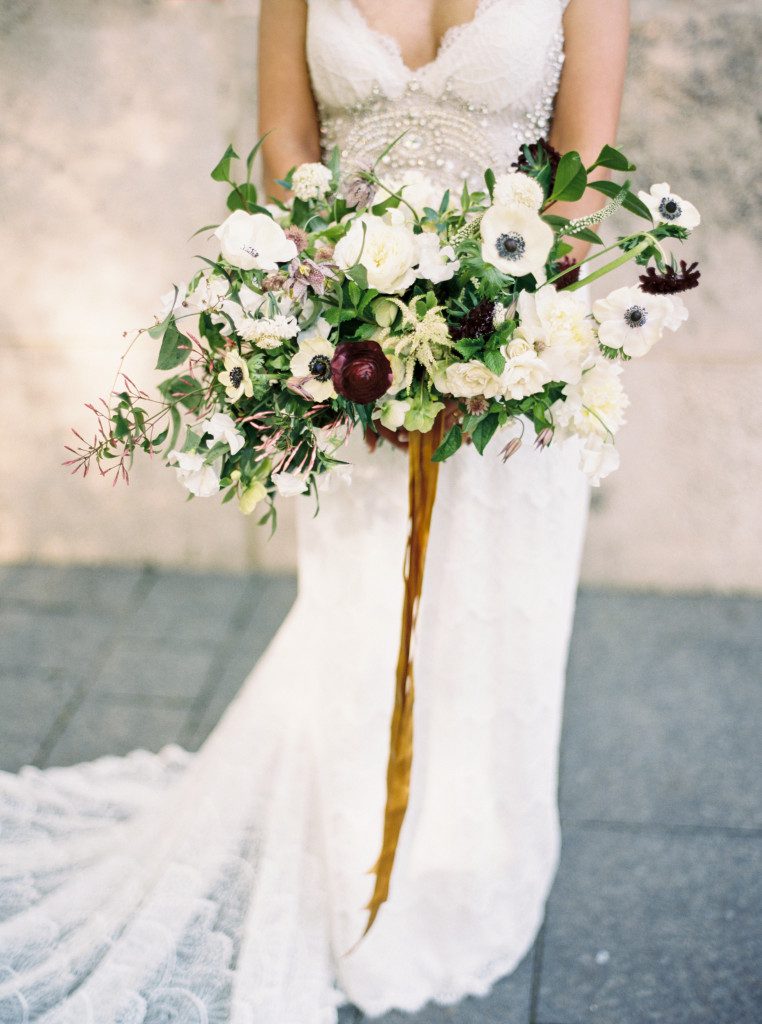 anemone bridal bouquet with plum ranunculus at a Nasher Sculpture Center wedding