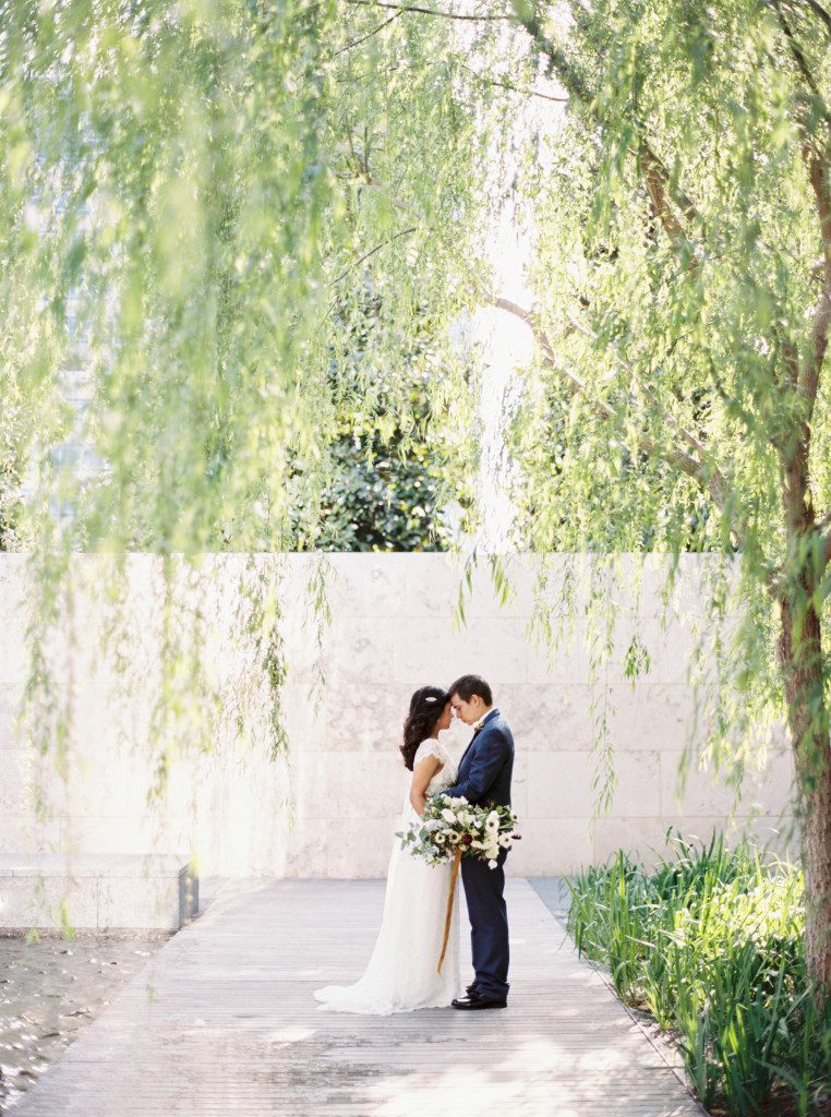 bride and groom under the trees at a Nasher Sculpture Center wedding