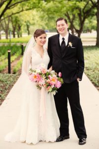 Bride and groom holding bouquet after wedding ceremony