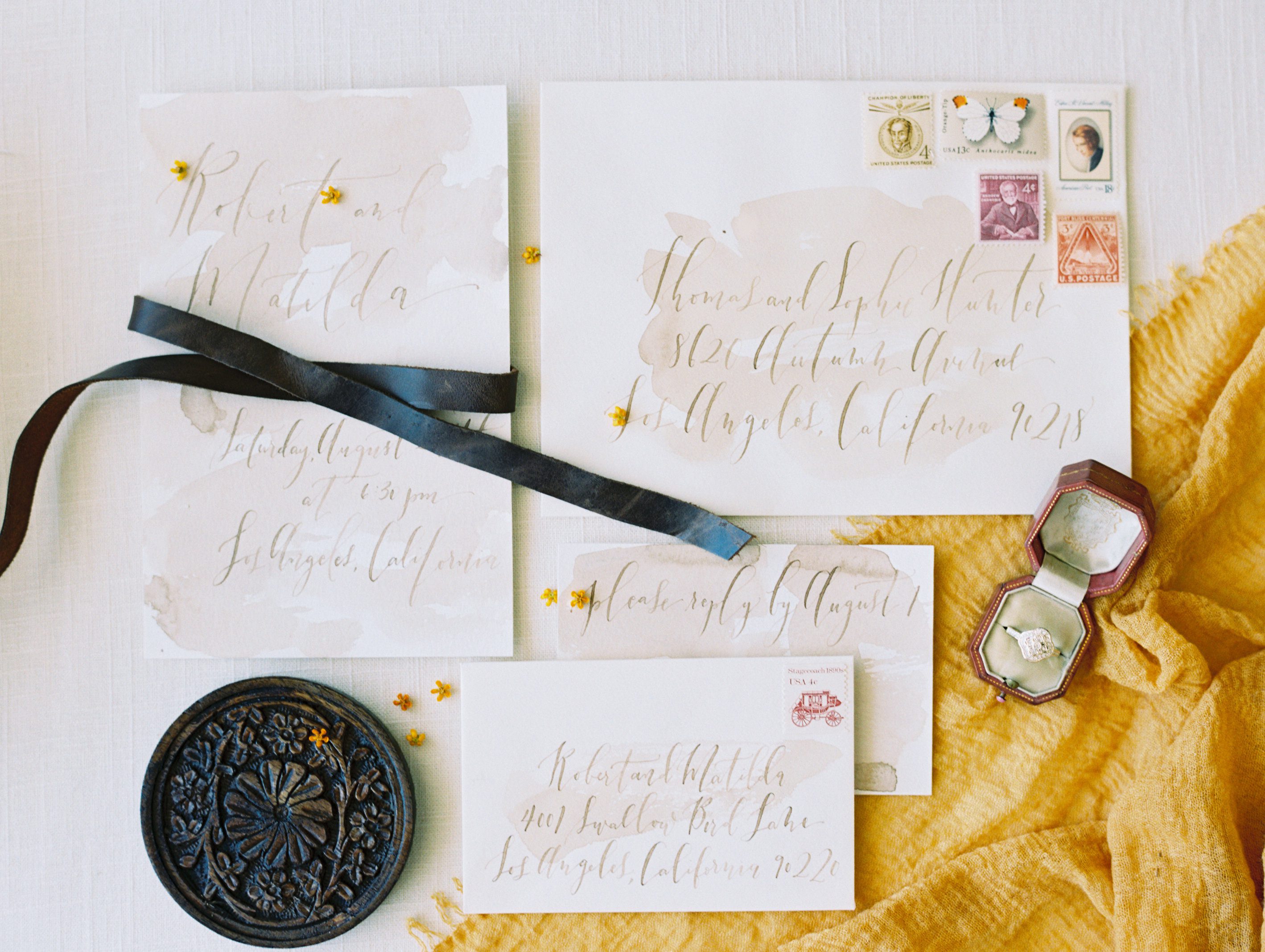 hand written wedding invitation styled with leather