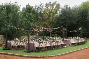 Long wedding tables under string lights