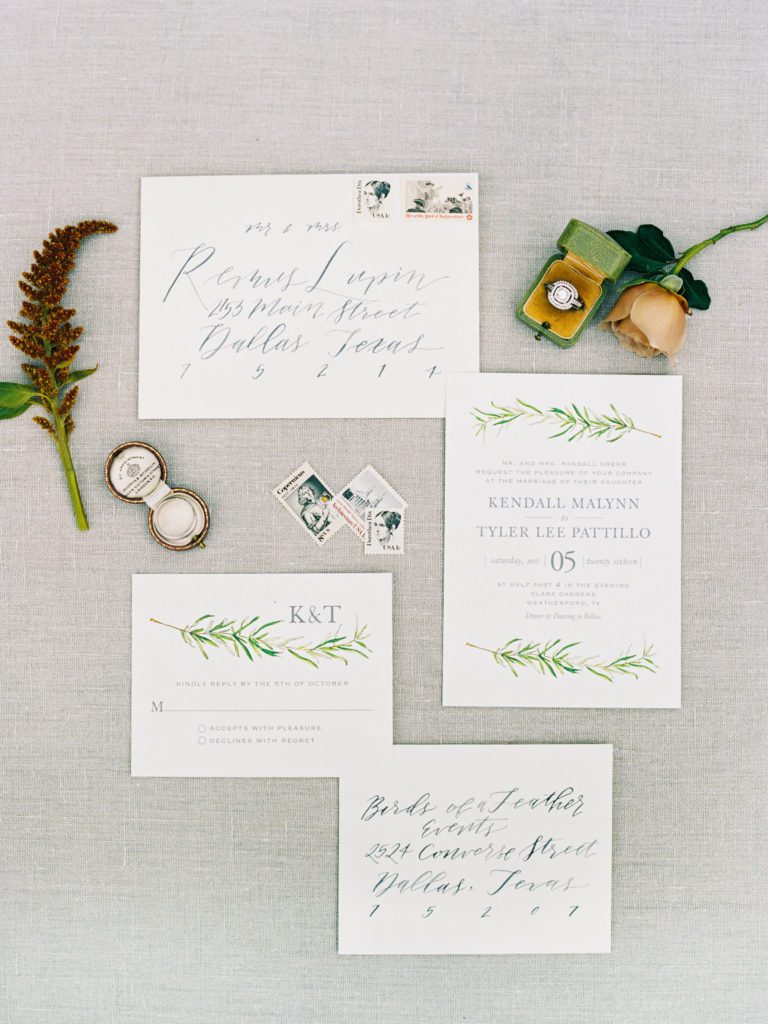 white and green wedding invitation styled with ring