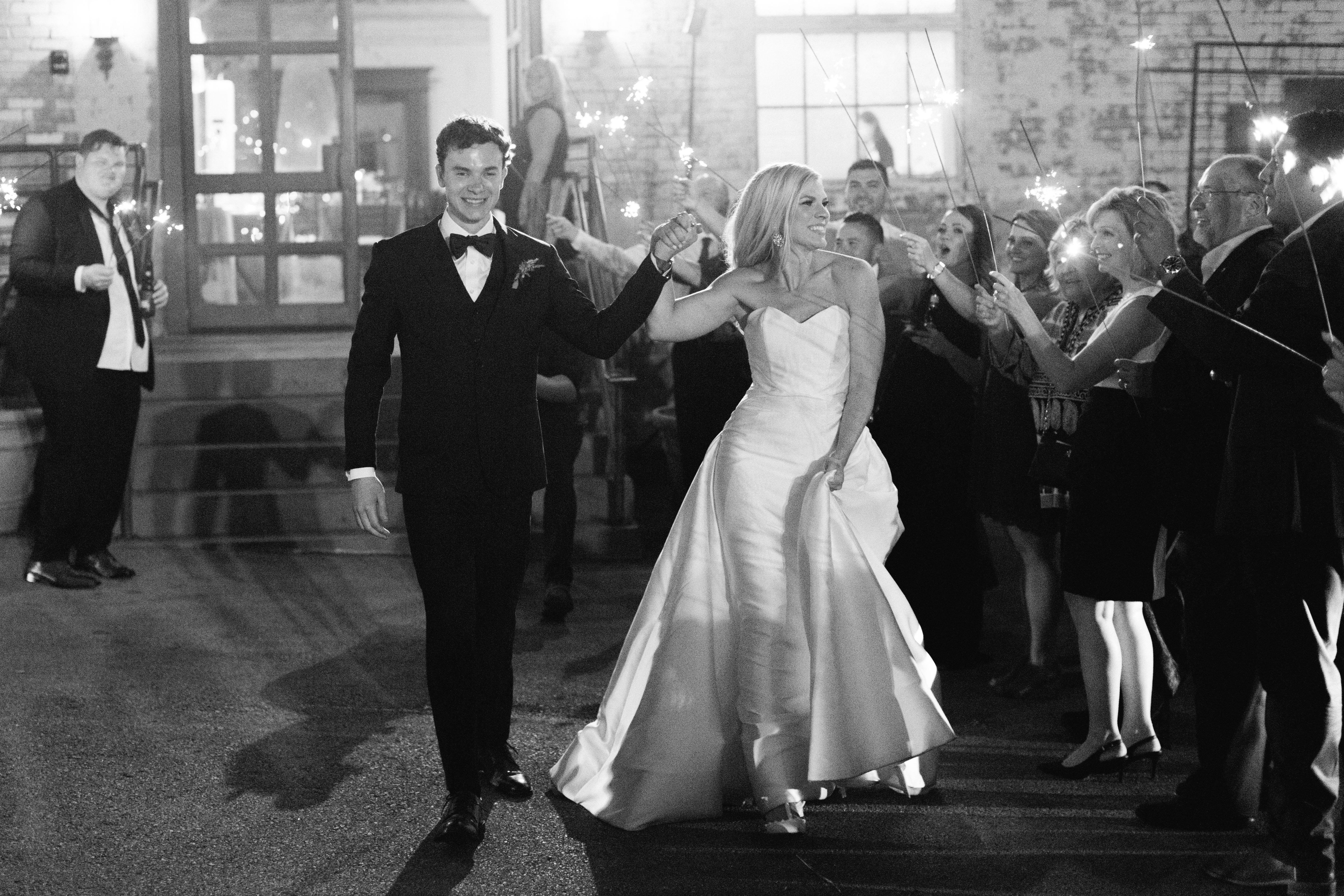 bride and groom exit with sparklers at a Brik Venue wedding in Fort Worth Texas planned and designed by Fort Worth wedding planner Birds of a Feather Events